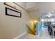 Hallway leading to a living room with coastal decor and luxury vinyl flooring at 9484 Tara Cay Ct # 8, Seminole, FL 33776