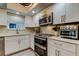 Well-equipped kitchen with modern stainless steel appliances and ample countertop space at 9484 Tara Cay Ct # 8, Seminole, FL 33776