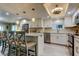 The kitchen features white cabinets, an island with bar seating, and stainless steel appliances at 9484 Tara Cay Ct # 8, Seminole, FL 33776