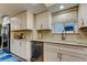 Bright kitchen features white cabinets, stainless steel appliances, light countertops, and subway tile backsplash at 9484 Tara Cay Ct # 8, Seminole, FL 33776
