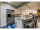 Bright kitchen features a stainless steel fridge and a breakfast bar with pendant lighting at 9484 Tara Cay Ct # 8, Seminole, FL 33776