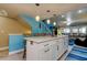 The kitchen island has a sleek countertop, cabinet storage, and bar seating overlooking the living room at 9484 Tara Cay Ct # 8, Seminole, FL 33776
