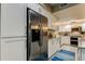 Kitchen with stainless steel appliances, a refrigerator, and white cabinetry at 9484 Tara Cay Ct # 8, Seminole, FL 33776