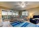 Cozy living room with a comfortable sofa, ceiling fan, and sliding glass doors to the outdoor balcony at 9484 Tara Cay Ct # 8, Seminole, FL 33776
