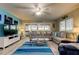 Inviting living room featuring a large sectional sofa, modern decor, and access to an outdoor balcony at 9484 Tara Cay Ct # 8, Seminole, FL 33776