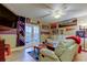 A cozy living room featuring a TV, white leather sofa, and memorabilia decorations at 9484 Tara Cay Ct # 8, Seminole, FL 33776
