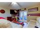 Comfortable living room featuring a mounted TV, fan, and french doors leading to the outdoors at 9484 Tara Cay Ct # 8, Seminole, FL 33776