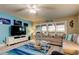 Stylish living room with a blue accent wall, cozy seating, and a sliding glass door to a balcony at 9484 Tara Cay Ct # 8, Seminole, FL 33776