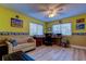 Bright home office featuring yellow walls and laminate flooring at 9484 Tara Cay Ct # 8, Seminole, FL 33776