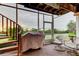 Relaxing screened porch with outdoor seating, a grill, and a view of the greenery at 9484 Tara Cay Ct # 8, Seminole, FL 33776