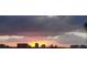 Scenic sunset view featuring the landscape, the water, and skyline buildings at 9484 Tara Cay Ct # 8, Seminole, FL 33776