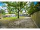 Expansive backyard showcasing a patio with outdoor furniture, storage shed, mature trees, and a wooden fence perimeter at 1005 Monroe St, Plant City, FL 33565