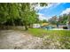 Spacious backyard featuring a patio with sunshade, outdoor seating, storage shed, and ample space for entertaining at 1005 Monroe St, Plant City, FL 33565