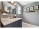 Stylish bathroom with a large mirror, elegant vanity, and decorative artwork at 1005 Monroe St, Plant City, FL 33565