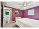 Cozy bedroom featuring a ceiling fan, a window with blinds, and carpeted floors, creating a comfortable retreat at 1005 Monroe St, Plant City, FL 33565