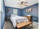 Well-lit bedroom with blue walls, queen-sized bed, ceiling fan, and stylish decor at 1005 Monroe St, Plant City, FL 33565
