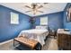 Stylized blue bedroom featuring a queen bed, modern lighting and decorative accents at 1005 Monroe St, Plant City, FL 33565