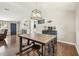 Dining room featuring a modern industrial table, stools, and view into the living room at 1005 Monroe St, Plant City, FL 33565