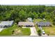 Charming single-story home featuring a well-kept front lawn, long driveway, and inviting yellow front door at 1005 Monroe St, Plant City, FL 33565