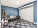 Spacious garage featuring a roll up door and checkered floors offering ample room for parking and storage at 1005 Monroe St, Plant City, FL 33565