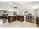 Open-concept kitchen with island, modern lighting, and hardwood flooring in the adjacent living room at 1005 Monroe St, Plant City, FL 33565