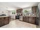 Spacious kitchen featuring stainless steel appliances, stylish backsplash, and granite countertops at 1005 Monroe St, Plant City, FL 33565