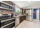 Beautiful kitchen with stainless steel appliances, granite countertops, and mosaic backsplash at 1005 Monroe St, Plant City, FL 33565