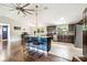 Modern kitchen with stainless steel appliances, a blue island, and stylish barstool seating at 1005 Monroe St, Plant City, FL 33565