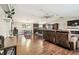 Spacious living room and kitchen featuring modern flooring, fan, and natural light at 1005 Monroe St, Plant City, FL 33565