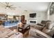 Open-concept layout with a fireplace, large tv, barstool seating, and stylish flooring at 1005 Monroe St, Plant City, FL 33565
