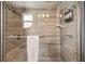Modern tiled shower with glass door, rainfall showerhead, and built-in shelving at 1005 Monroe St, Plant City, FL 33565