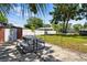 A spacious backyard featuring a picnic table, storage shed, and a white privacy fence at 1013 N Bask Dr, Tampa, FL 33603