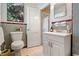Bathroom features a vanity, toilet, tile walls, and a decorative artwork in the corner at 1013 N Bask Dr, Tampa, FL 33603