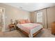 Bright bedroom with natural light, neutral walls, and a classic wooden bed frame at 1013 N Bask Dr, Tampa, FL 33603