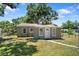 Classic one-story home featuring a freshly painted exterior, large yard, and inviting front entrance at 1013 N Bask Dr, Tampa, FL 33603