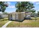 Quaint single-Gathering home with a well-manicured lawn, fenced yard and an inviting facade at 1013 N Bask Dr, Tampa, FL 33603