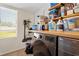 Laundry room is well-lit with washer and dryer and storage on wood shelving at 1013 N Bask Dr, Tampa, FL 33603