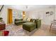 Bright living room with stylish decor, a comfortable green couch, and a patterned rug at 1013 N Bask Dr, Tampa, FL 33603