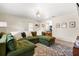 Spacious living room with an inviting green couch and access to the adjacent kitchen at 1013 N Bask Dr, Tampa, FL 33603