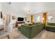 Cozy living room featuring tile floors, a large comfortable green couch, and natural light at 1013 N Bask Dr, Tampa, FL 33603