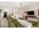 Modern living room with tile floors, a green couch, and an open layout connecting to the kitchen at 1013 N Bask Dr, Tampa, FL 33603