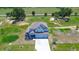 Expansive home with three-car garage on manicured lot with mature trees and a concrete driveway at 10517 Crestview Heights Ave, Thonotosassa, FL 33592