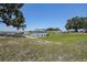 Backyard with a lush grassy hill and view of the house at 10517 Crestview Heights Ave, Thonotosassa, FL 33592