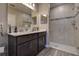 Bathroom features a double sink vanity, a tiled shower, and modern fixtures at 10517 Crestview Heights Ave, Thonotosassa, FL 33592