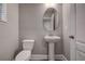 Neutral powder room features a pedestal sink and a round mirror at 10517 Crestview Heights Ave, Thonotosassa, FL 33592
