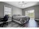 Comfortable bedroom featuring wood-look floors, a ceiling fan, and sliding door access to the outdoors at 10517 Crestview Heights Ave, Thonotosassa, FL 33592