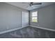 Neutral bedroom featuring plush carpet, ceiling fan, and closet at 10517 Crestview Heights Ave, Thonotosassa, FL 33592