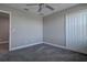 A light gray bedroom with plush gray carpet, a closet, and neutral colors at 10517 Crestview Heights Ave, Thonotosassa, FL 33592