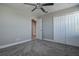 Bedroom featuring neutral paint, carpet, a ceiling fan, and a double closet at 10517 Crestview Heights Ave, Thonotosassa, FL 33592