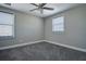 Bedroom featuring neutral paint, carpet, a ceiling fan, and two windows at 10517 Crestview Heights Ave, Thonotosassa, FL 33592